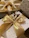 Close-up of a luxurious black and gold gift basket wrapped with a satin ribbon