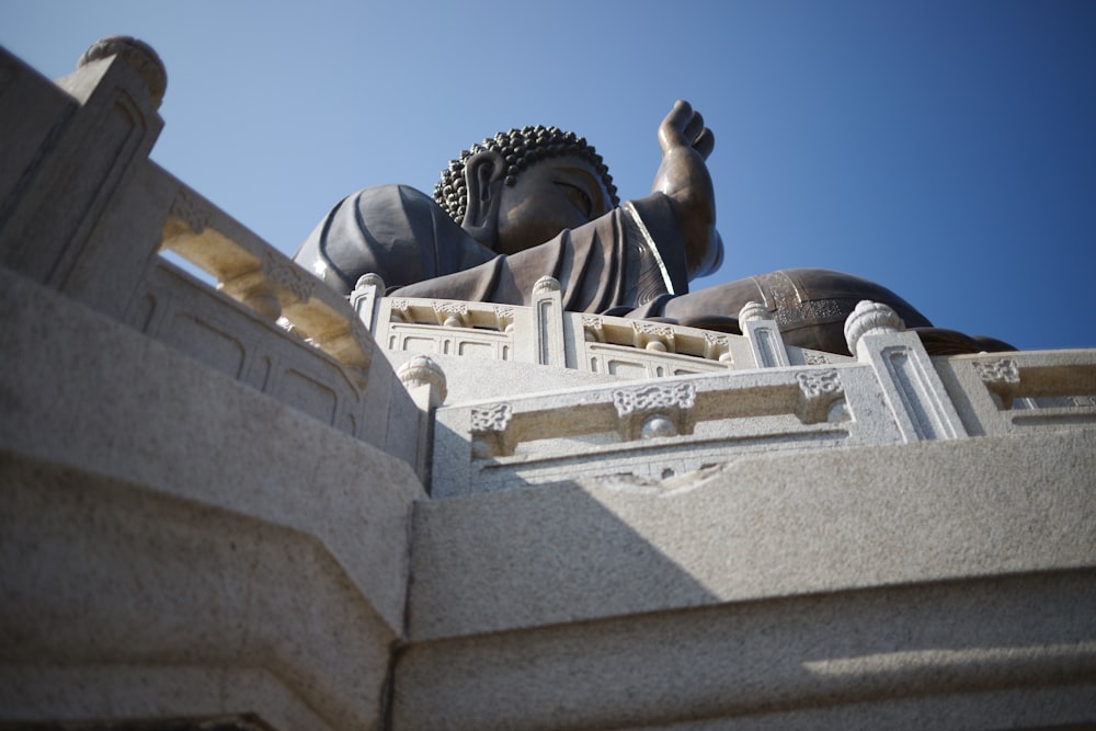 a statue of a buddha on top of a building