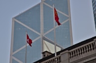 An office building in Dubai with flags of UAE and Pakistan fluttering outside.