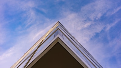 Photo of Vertex Corp team collaborating on a building site with clear blue sky.