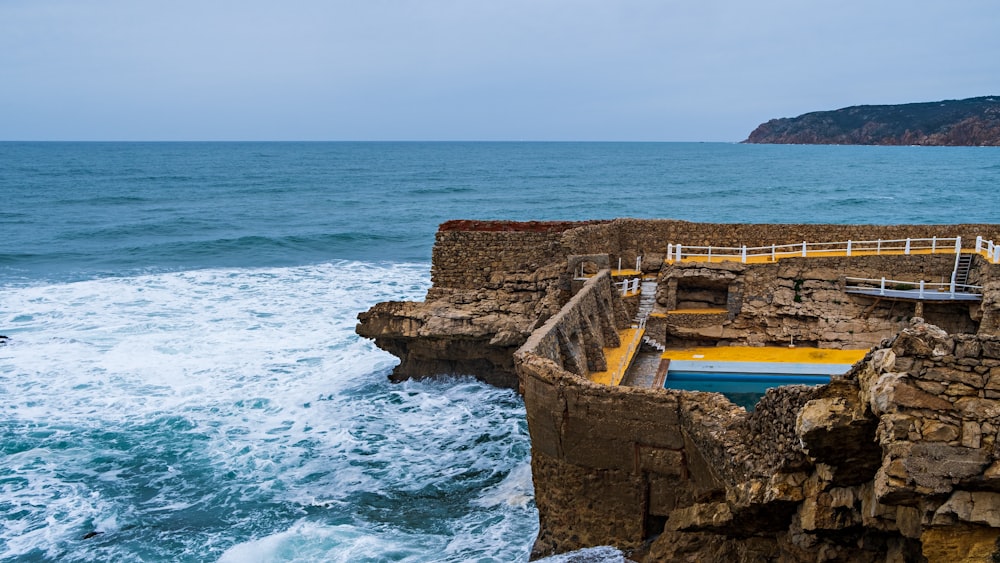 a rocky cliff overlooks a body of water