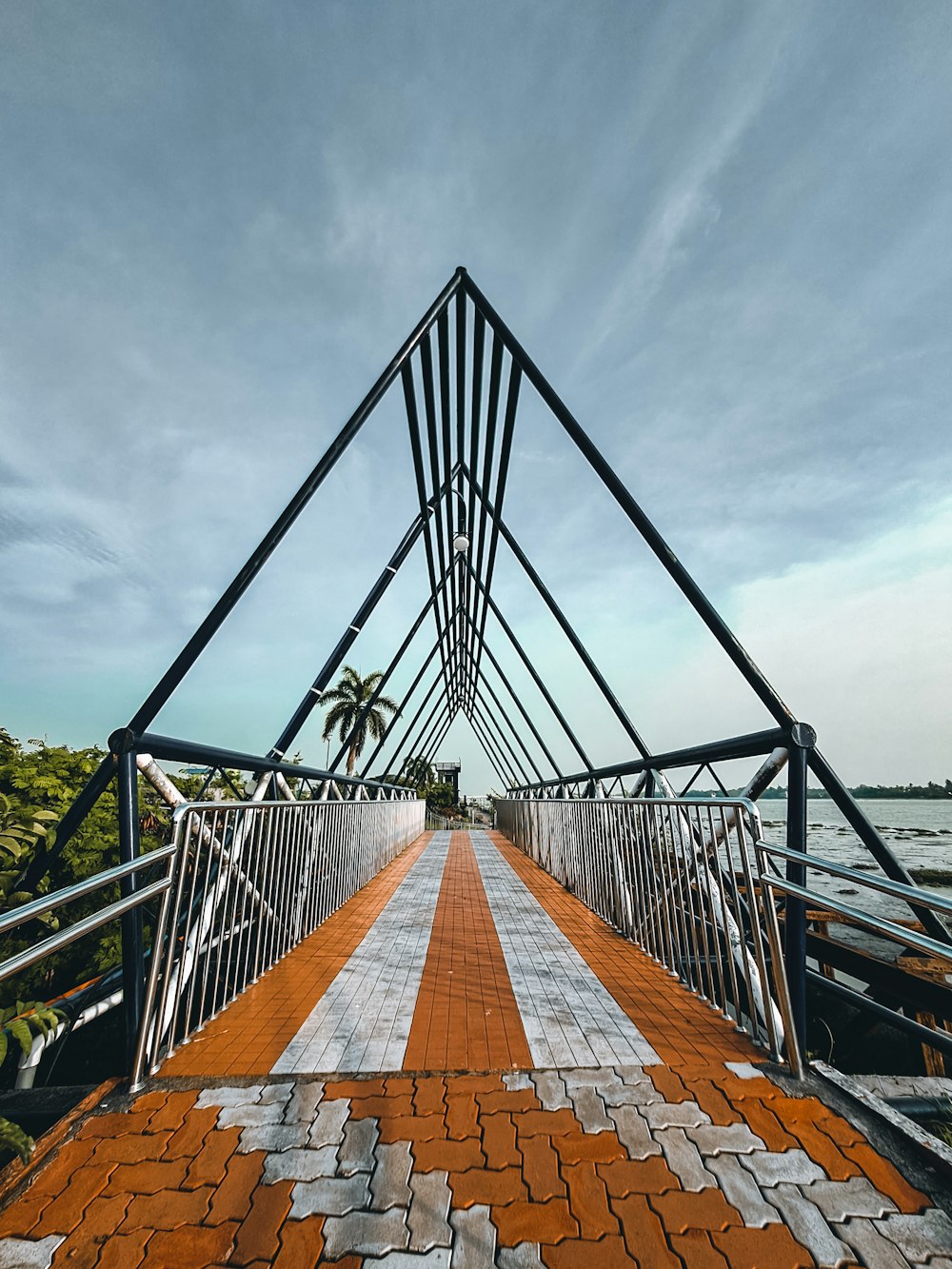 a bridge that has a brick walkway going across it