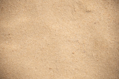 Close-up of fine silica sand with a soft, beige hue.