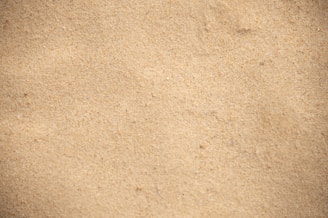 Close-up of fine silica sand with a soft, beige hue.