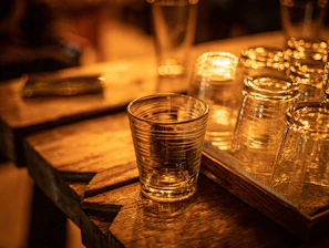 A set of custom engraved glassware catching the light on a cozy table.