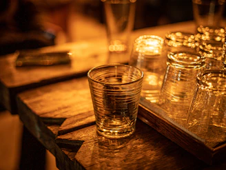 Elegant glassware set reflecting warm light on a wooden table