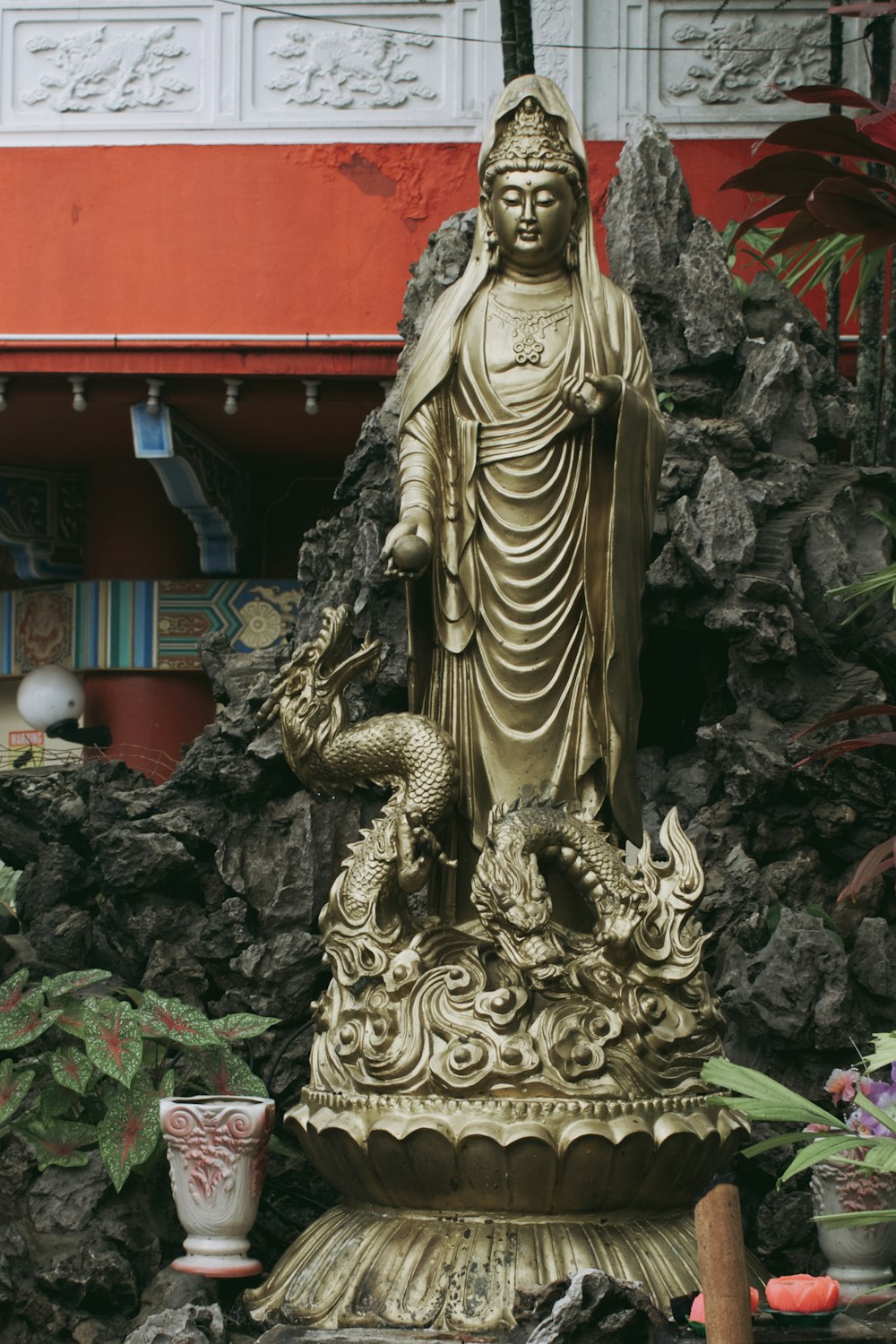 a statue of a buddha with a dragon on top of it
