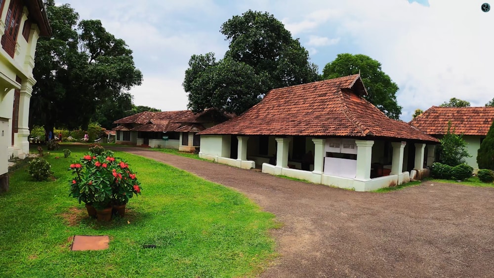 a couple of buildings sitting on top of a lush green field