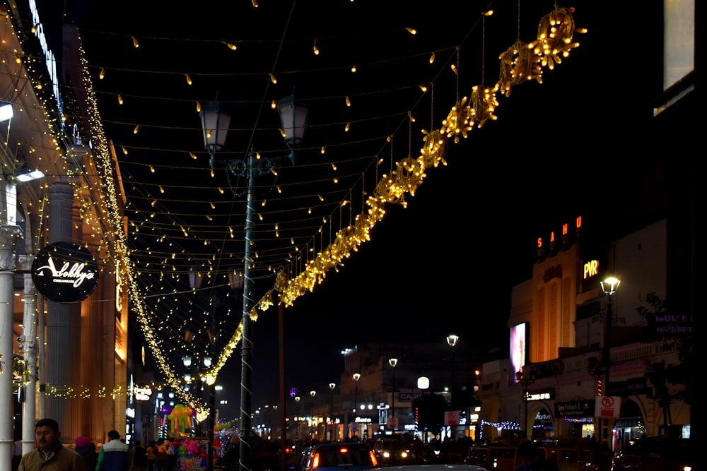 a city street is lit up with christmas lights