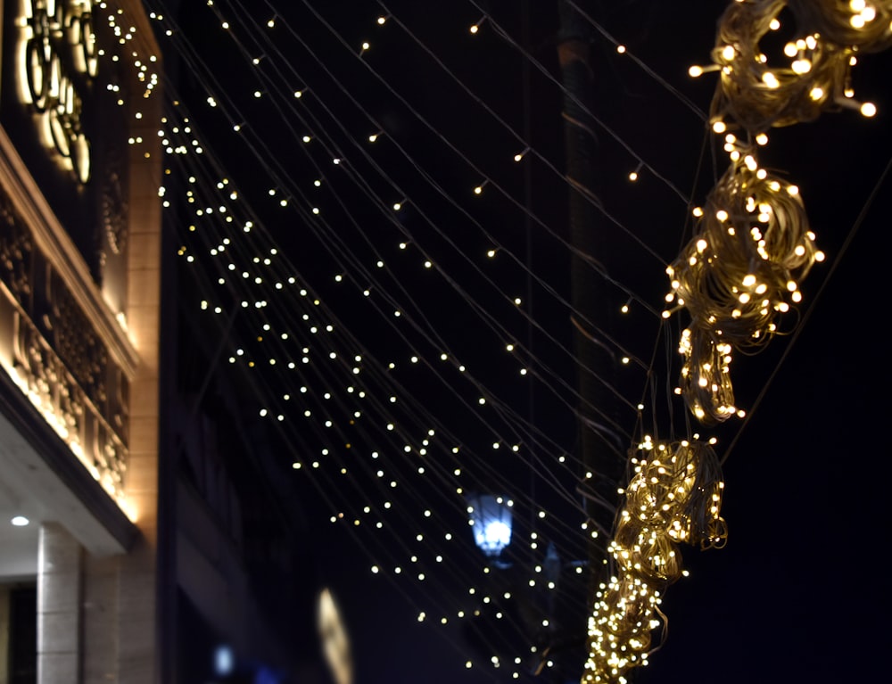 a clock on a building covered in christmas lights