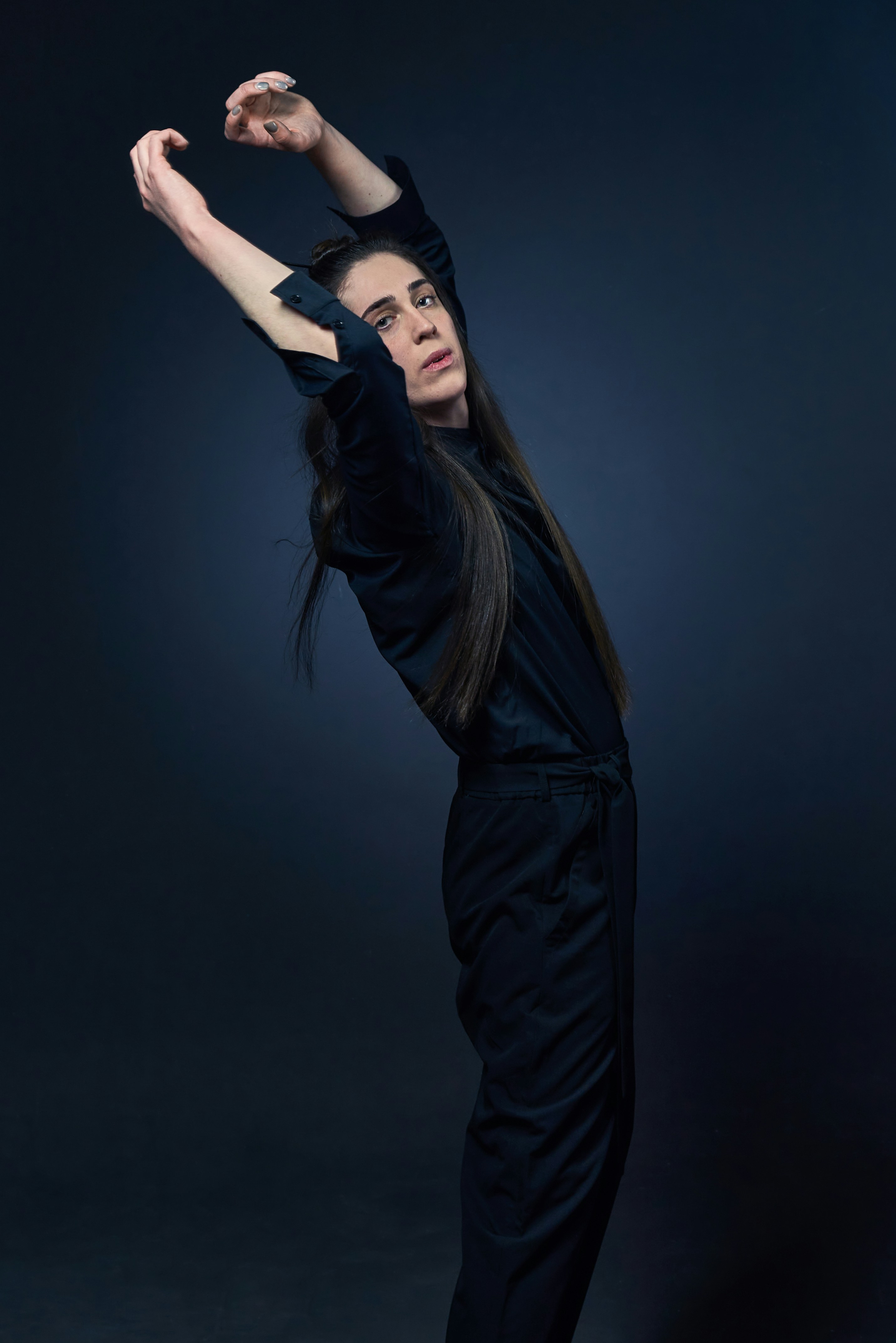 a woman in a black jumpsuit posing for a picture