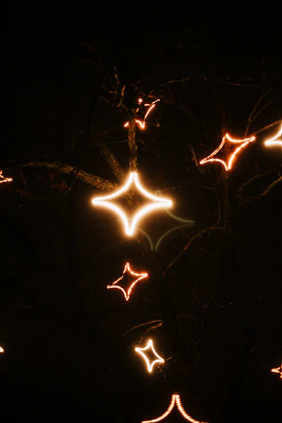 Softly glowing stars twinkling over a dark coffee brown background with warm cream text.