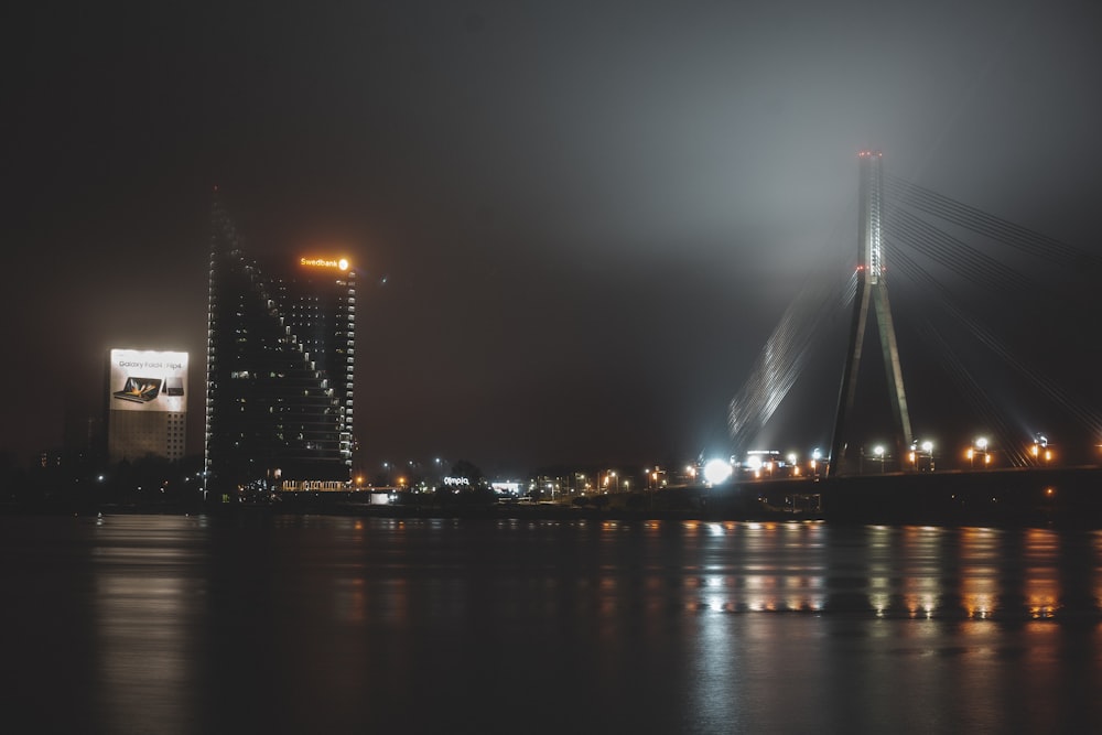 a night view of a bridge over a body of water