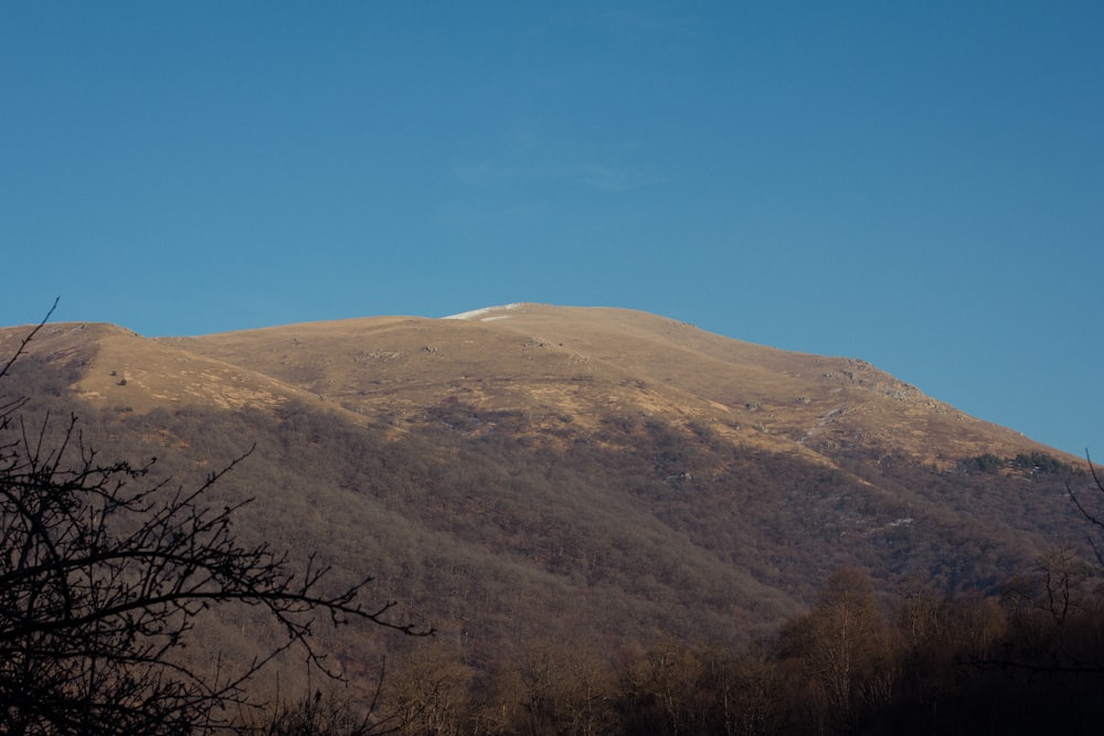 a view of a mountain with a clear blue sky