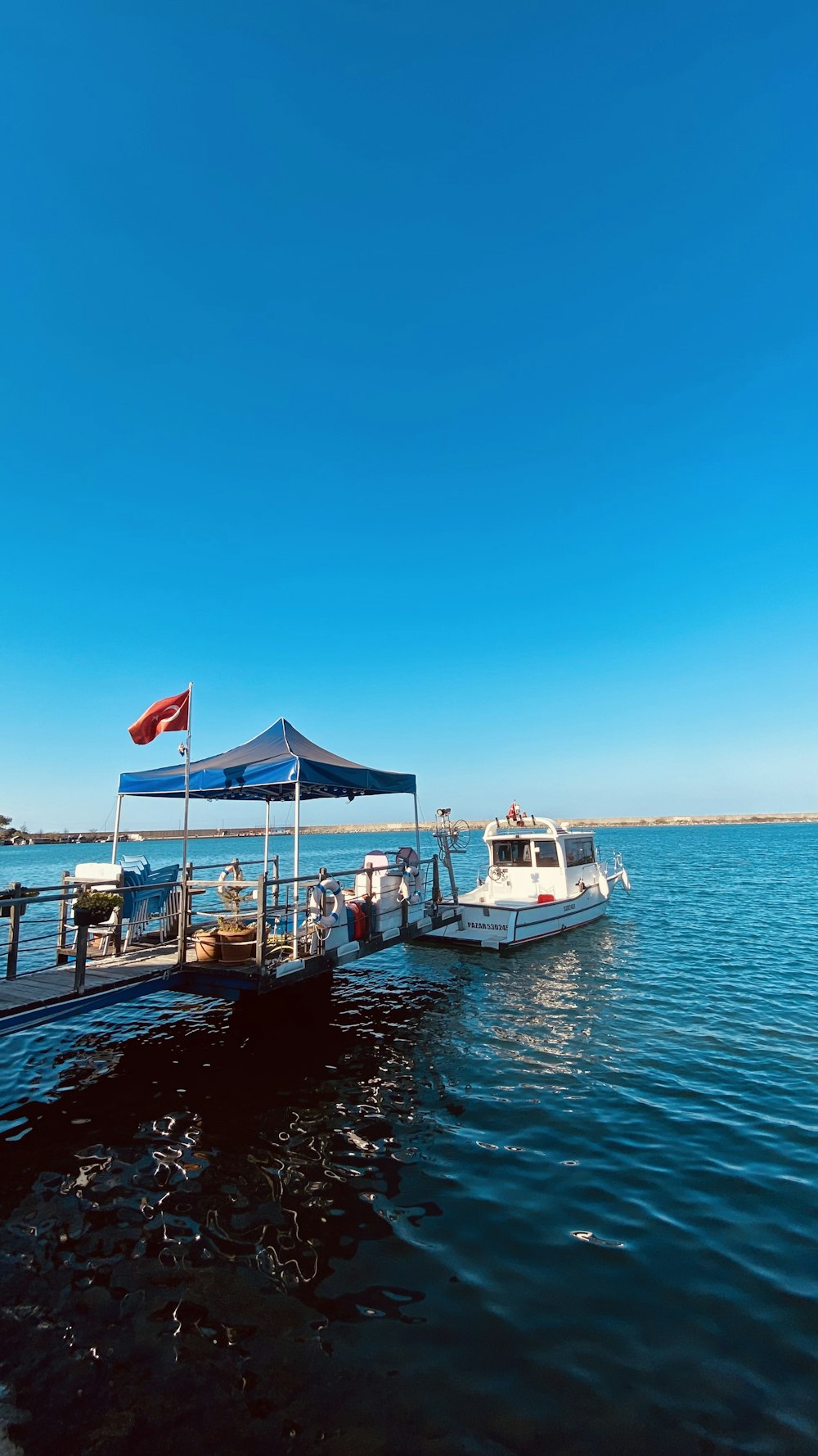 a boat is docked at a pier on the water