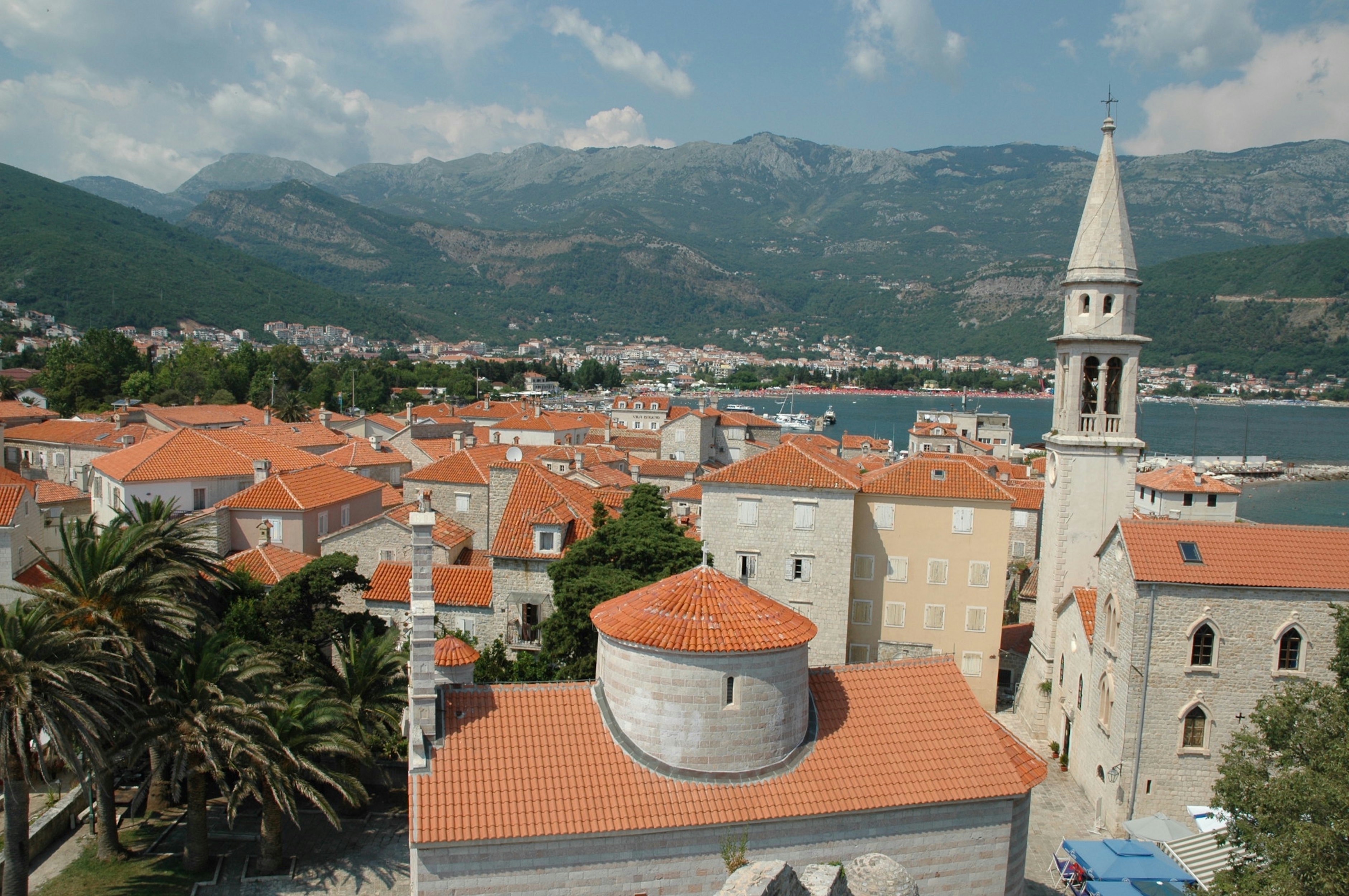 an aerial view of a city with mountains in the background