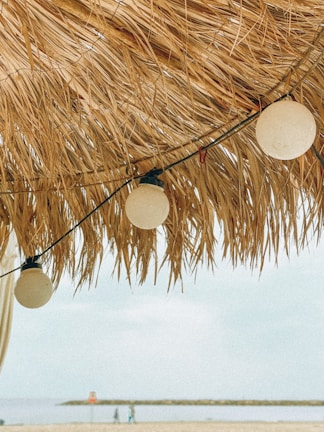 Close-up of a Madtre beach umbrella fabric fluttering gently in the ocean breeze.