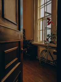 a bicycle is parked in a room with a window