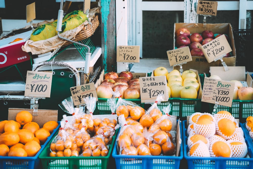 baskets of oranges, apples, and other fruit for sale