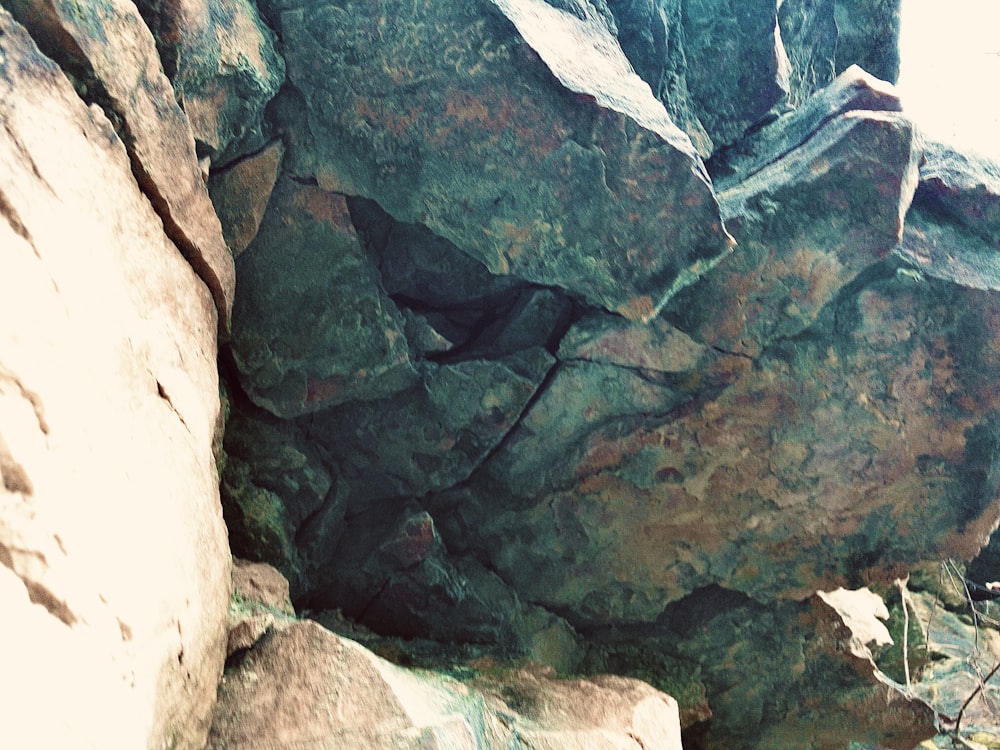 a person climbing up a large rock face