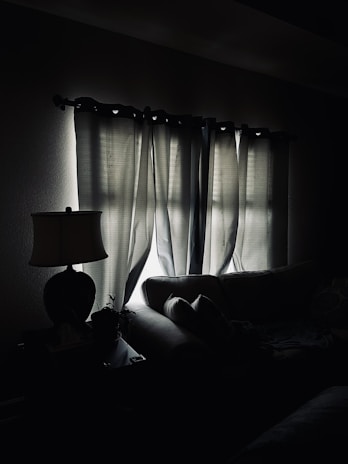 Clairlite in action, casting a gentle light over a living room sofa and cushions.