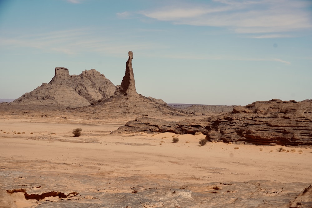 a large rock formation in the middle of a desert