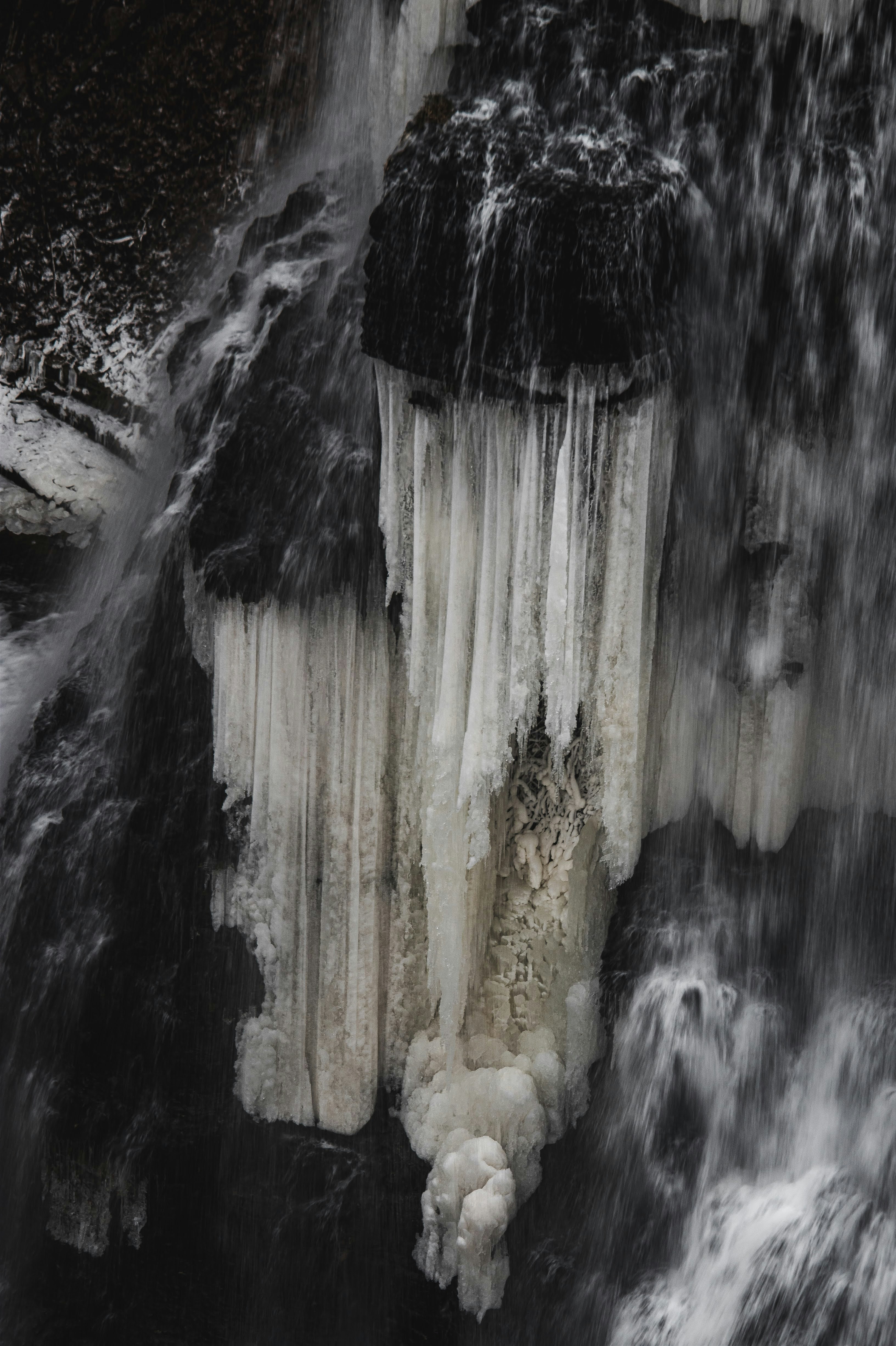 A waterfall with ice hanging off of it's sides photo – Free Burgess ...