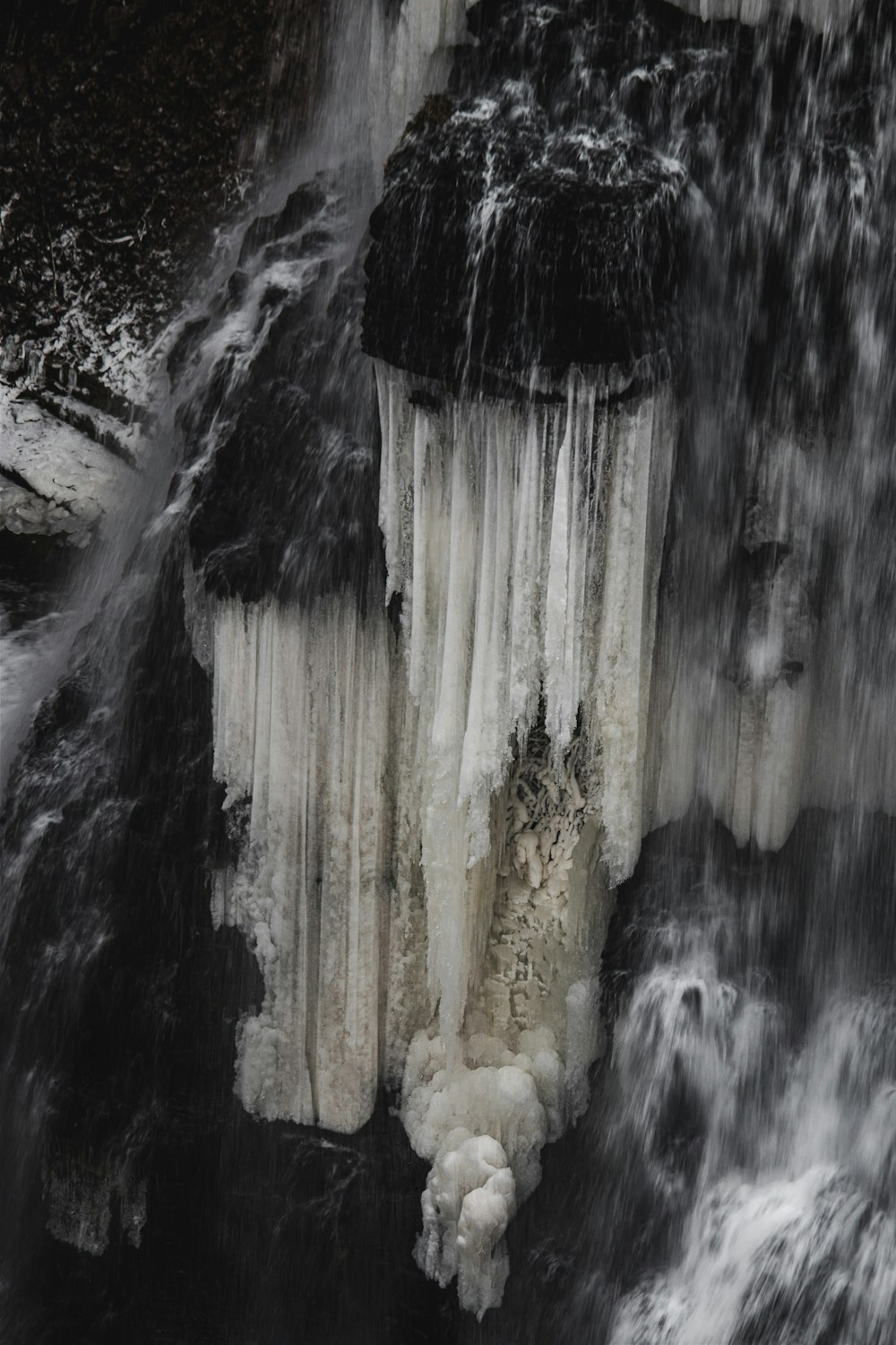 a waterfall with ice hanging off of it's sides