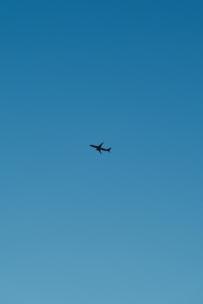 A vibrant image of an airplane taking off against a clear blue sky.