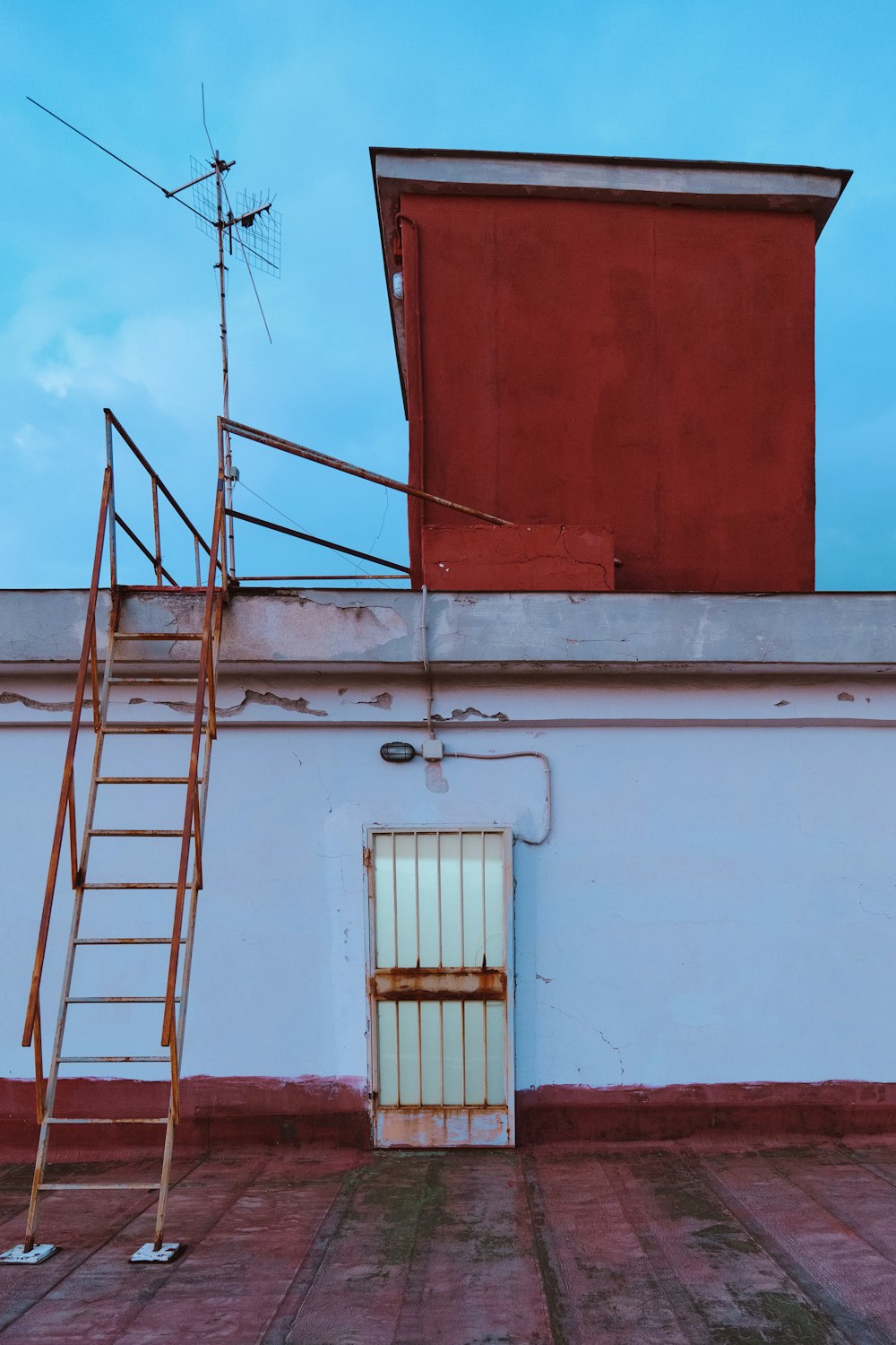 a ladder leaning against a wall next to a door