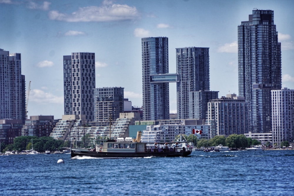 a boat in a body of water in front of a city