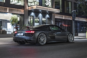Sleek, low-profile performance tire on a shiny sports car parked on a city street.