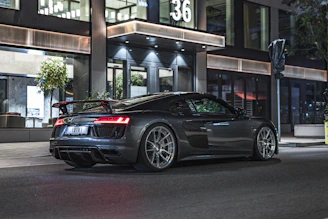 Sleek performance tires mounted on a shiny sports car parked on a city street.