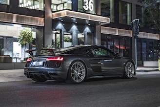 Sporty car with aerodynamic spoilers and polished rims on a city street
