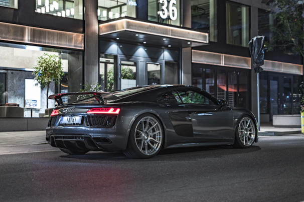 Sleek performance tires mounted on a shiny sports car parked on a city street.