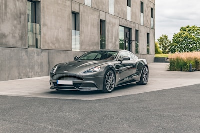 A sleek car parked outside a stylish urban home.