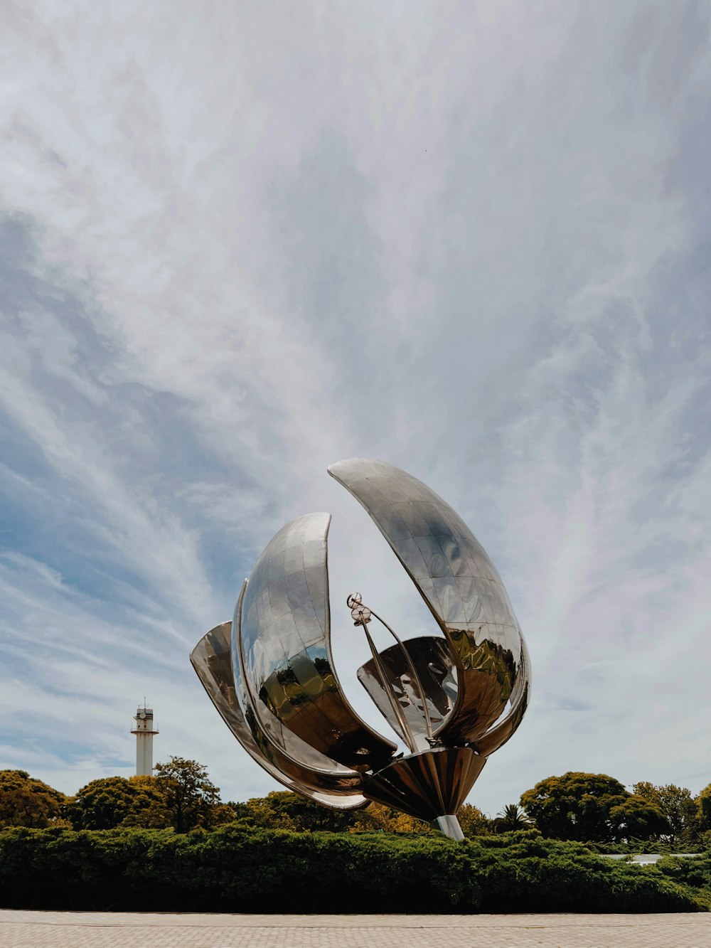 a large metal object sitting in the middle of a park