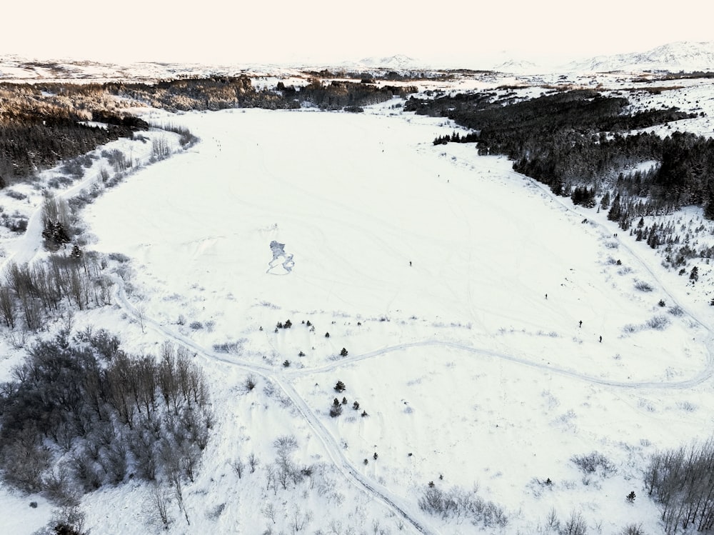 an aerial view of a snow covered field