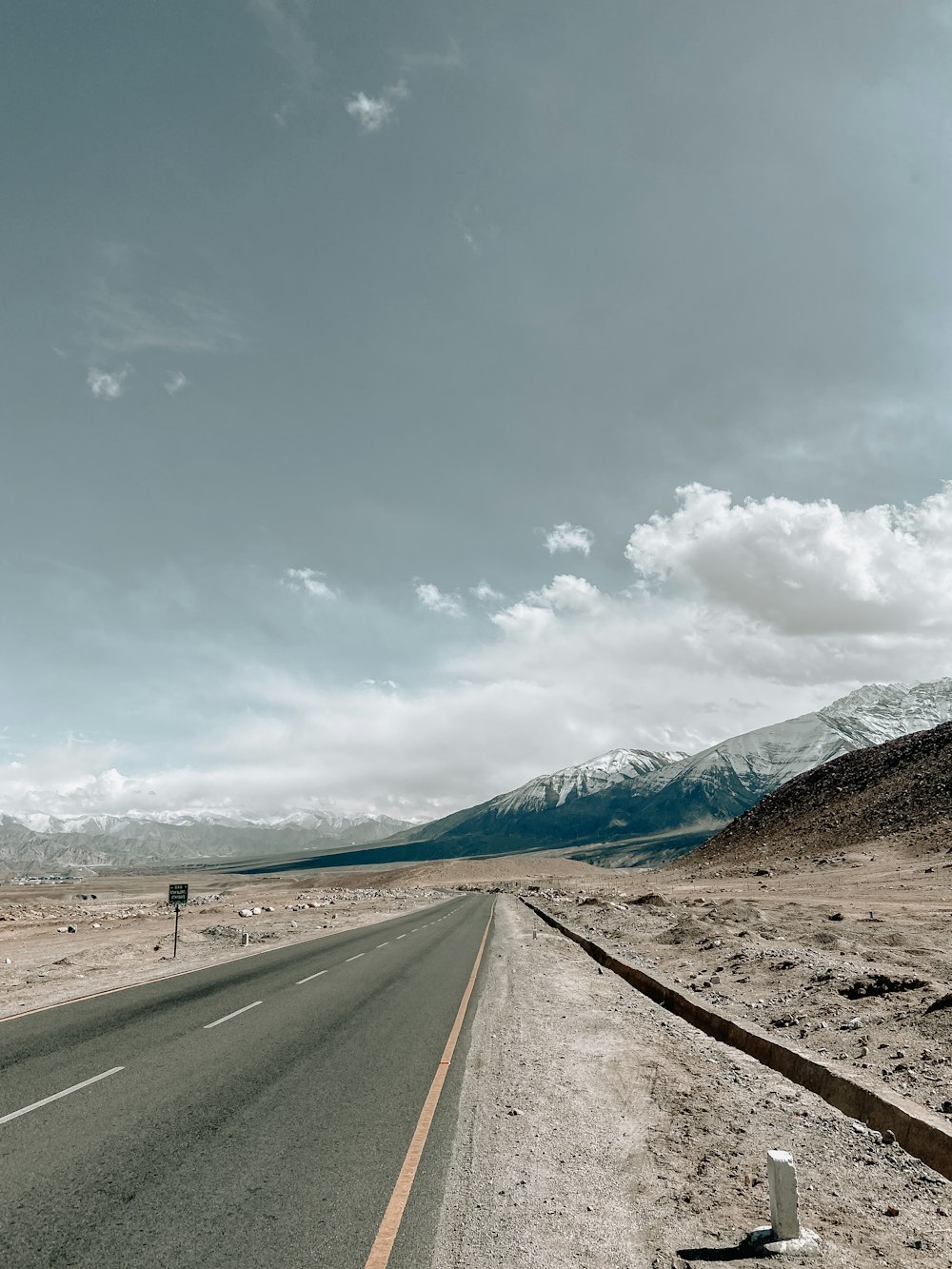 an empty road in the middle of the desert