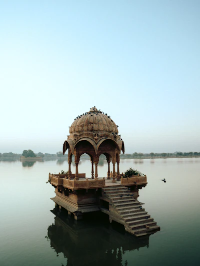 a gazebo sitting on top of a body of water