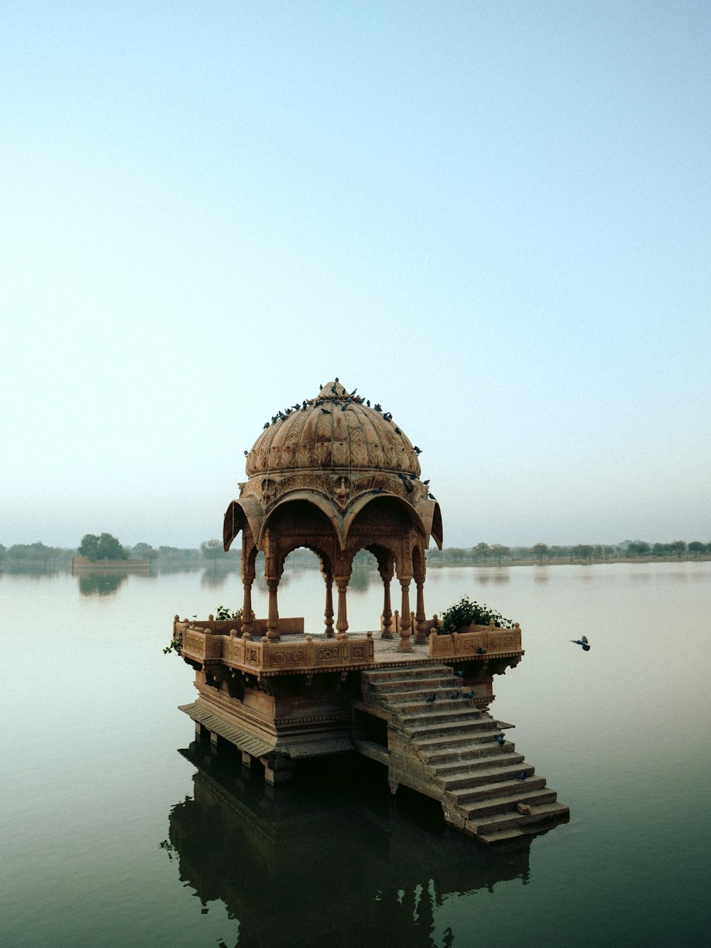 a gazebo sitting on top of a body of water