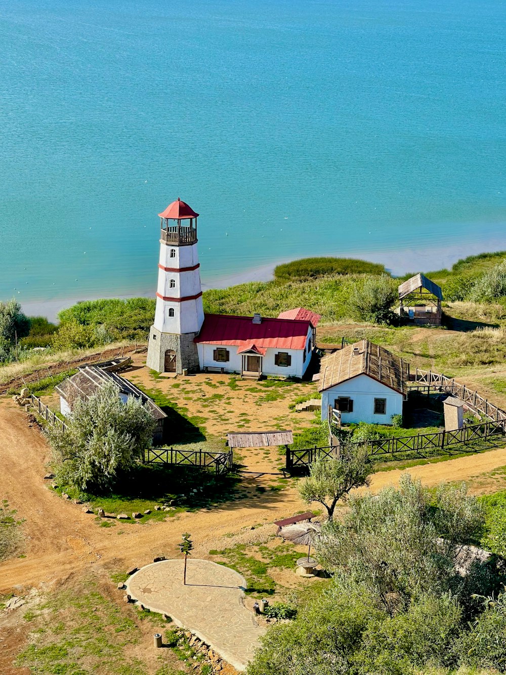 an aerial view of a lighthouse on a small island
