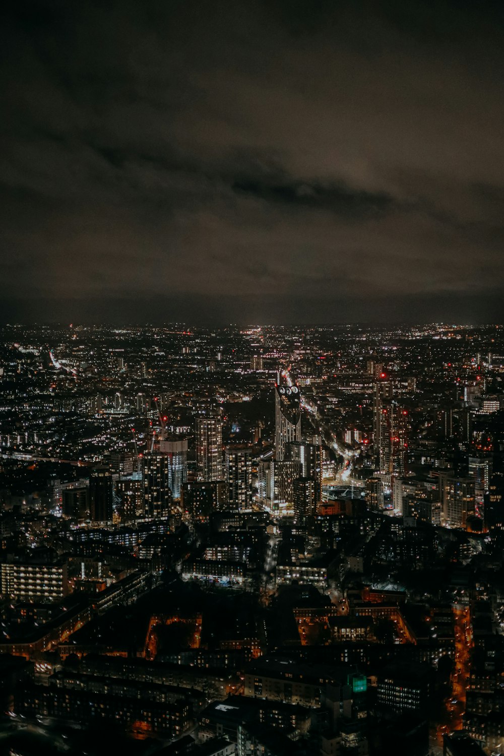 a view of a city at night from the top of a building