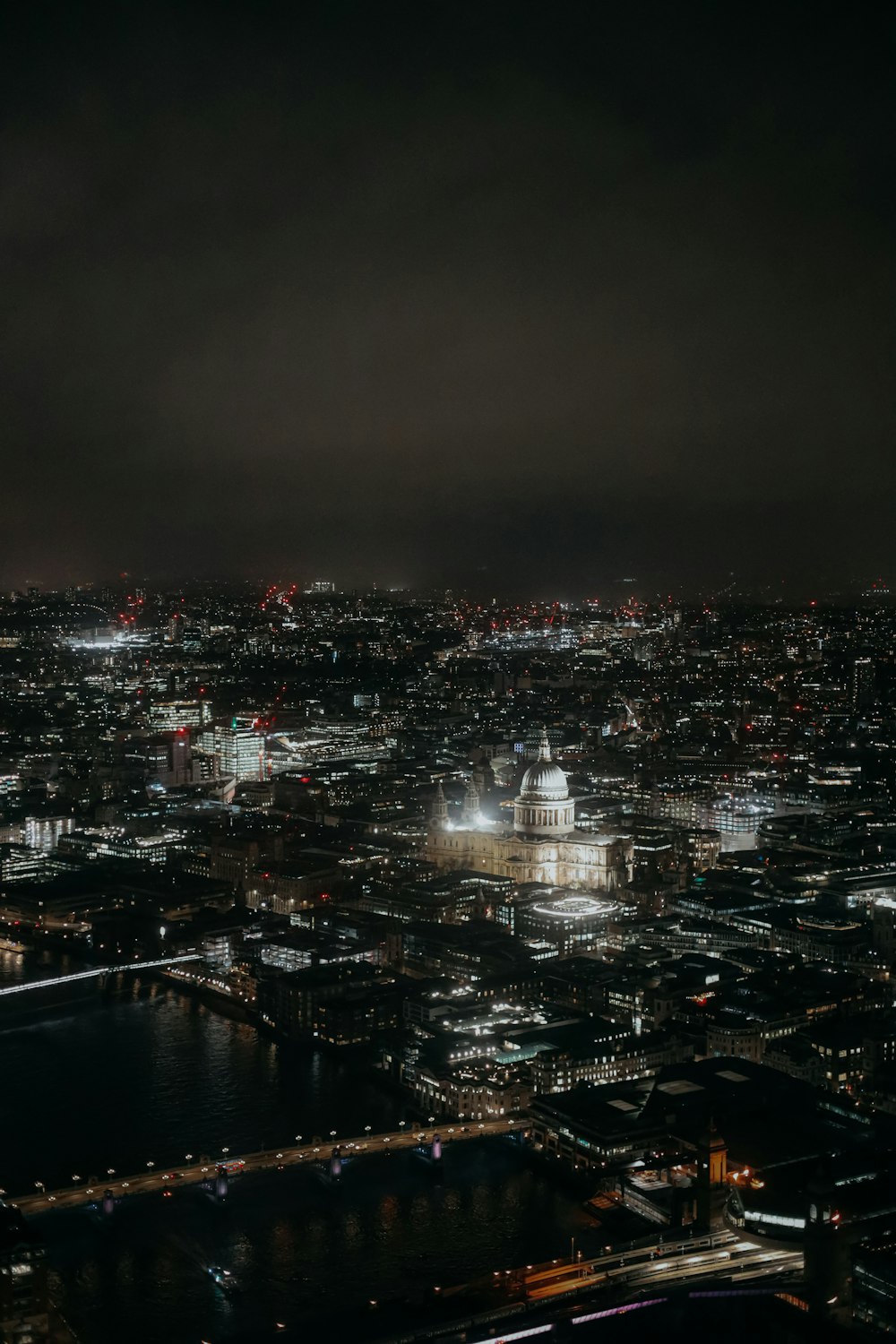 a view of a city at night from the top of a building