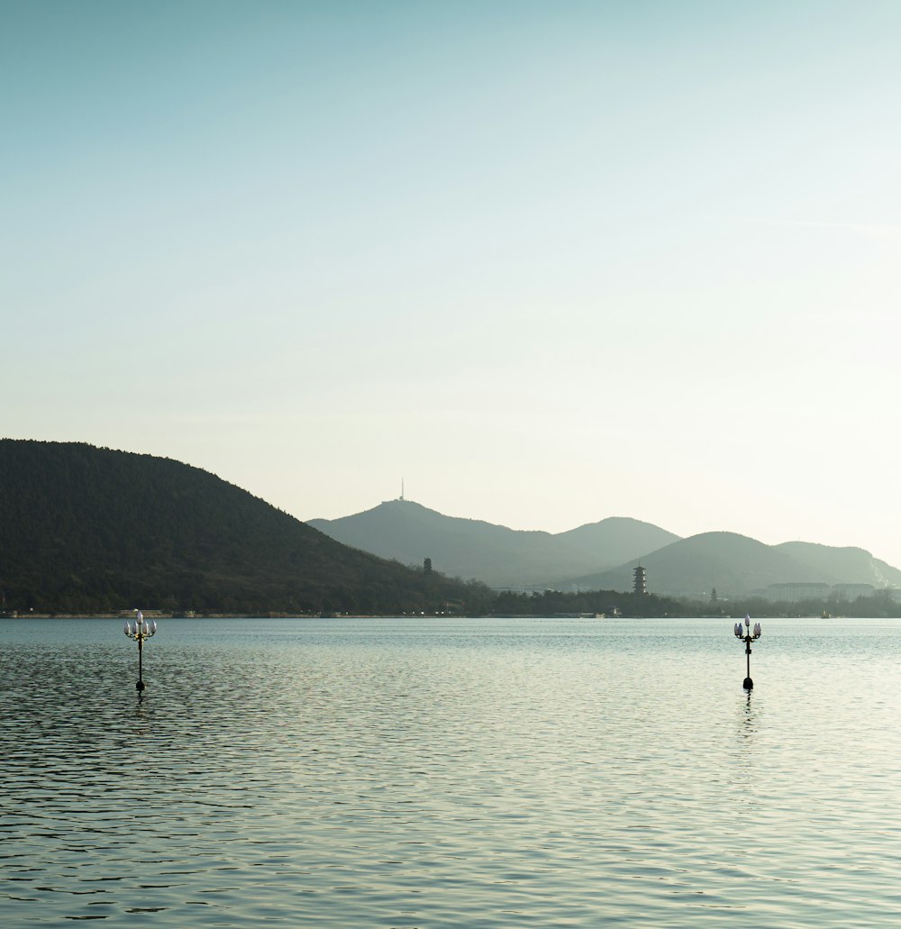 a large body of water with mountains in the background