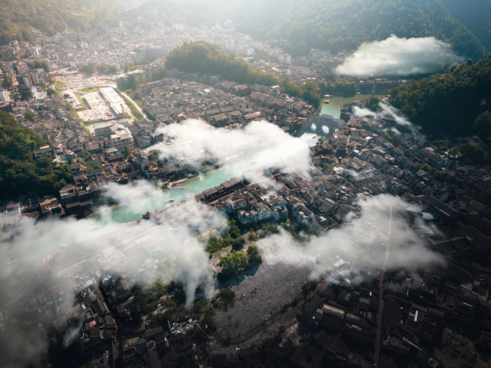 an aerial view of a city surrounded by clouds