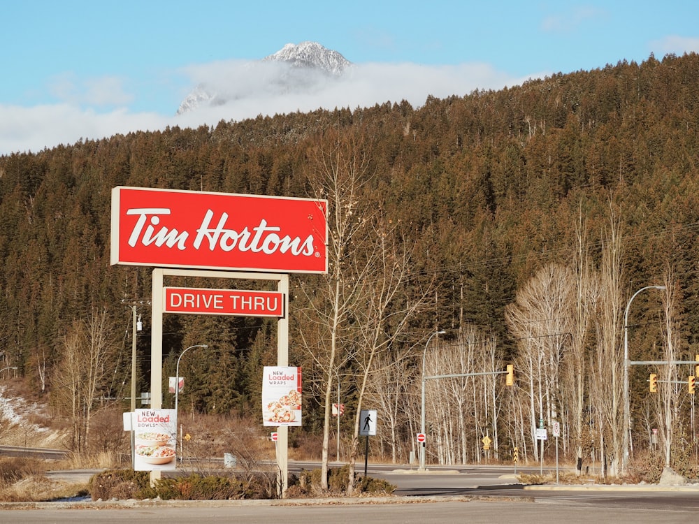 a red sign that says tim hortons drive thru