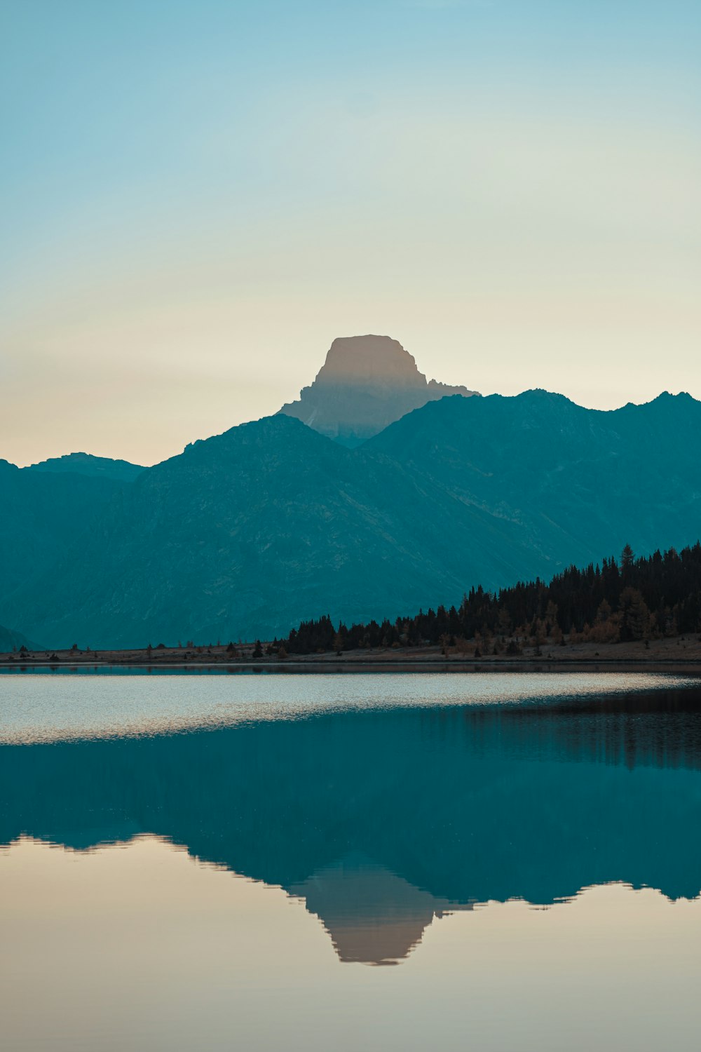 a large body of water with a mountain in the background