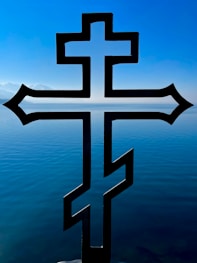 a cross that is sitting in the water