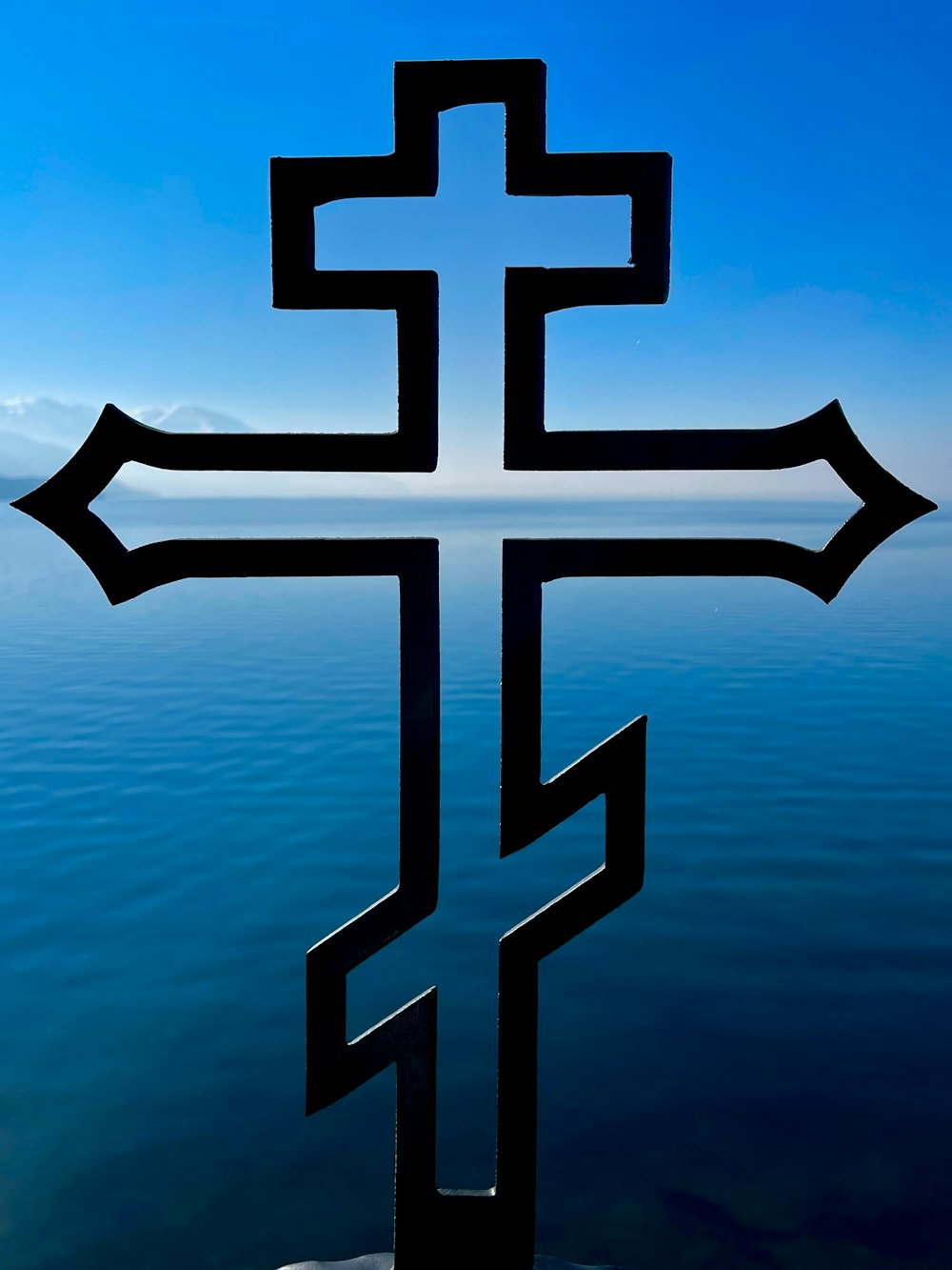 a cross that is sitting in the water